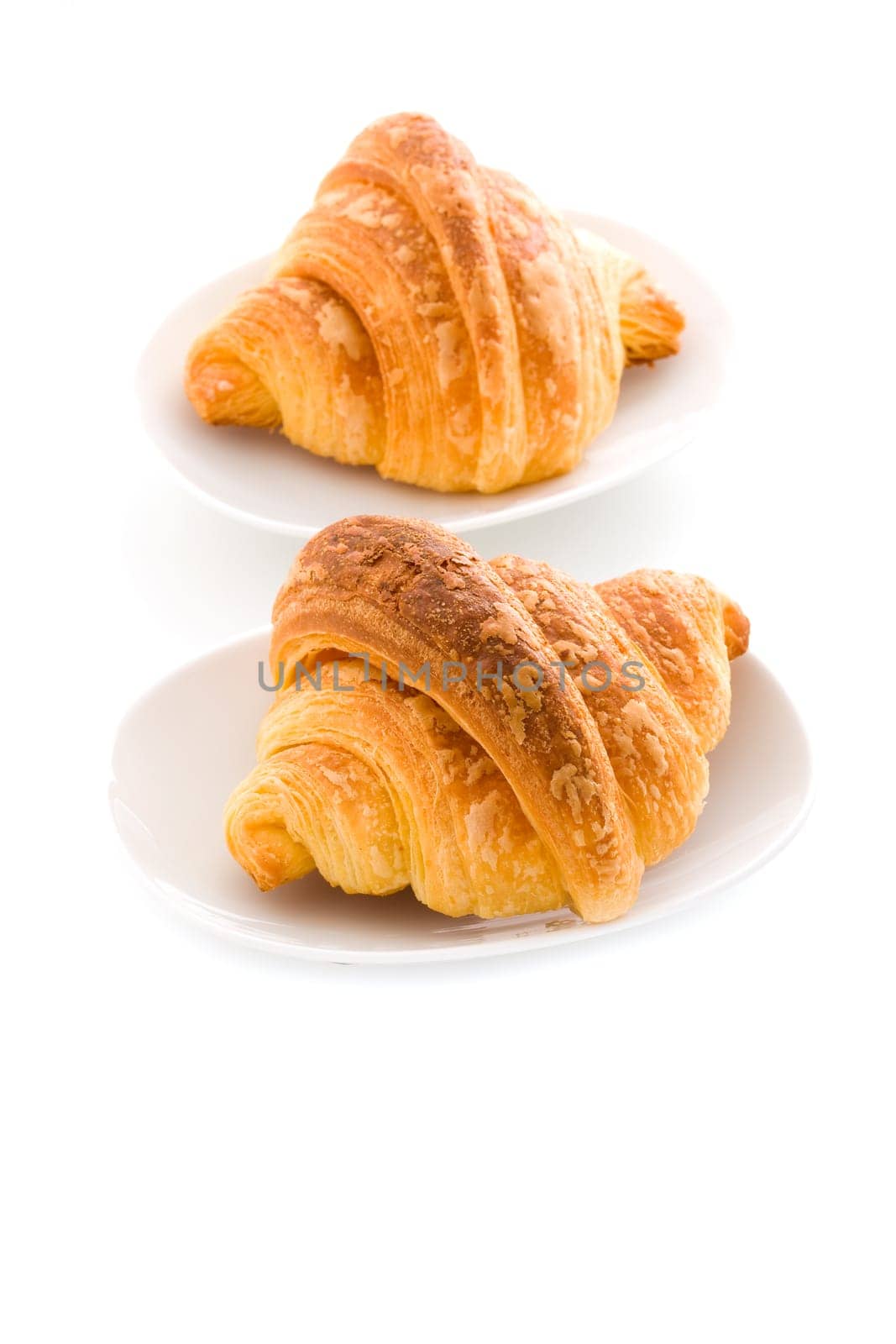 photo of delicious tasty golden croissants on white background