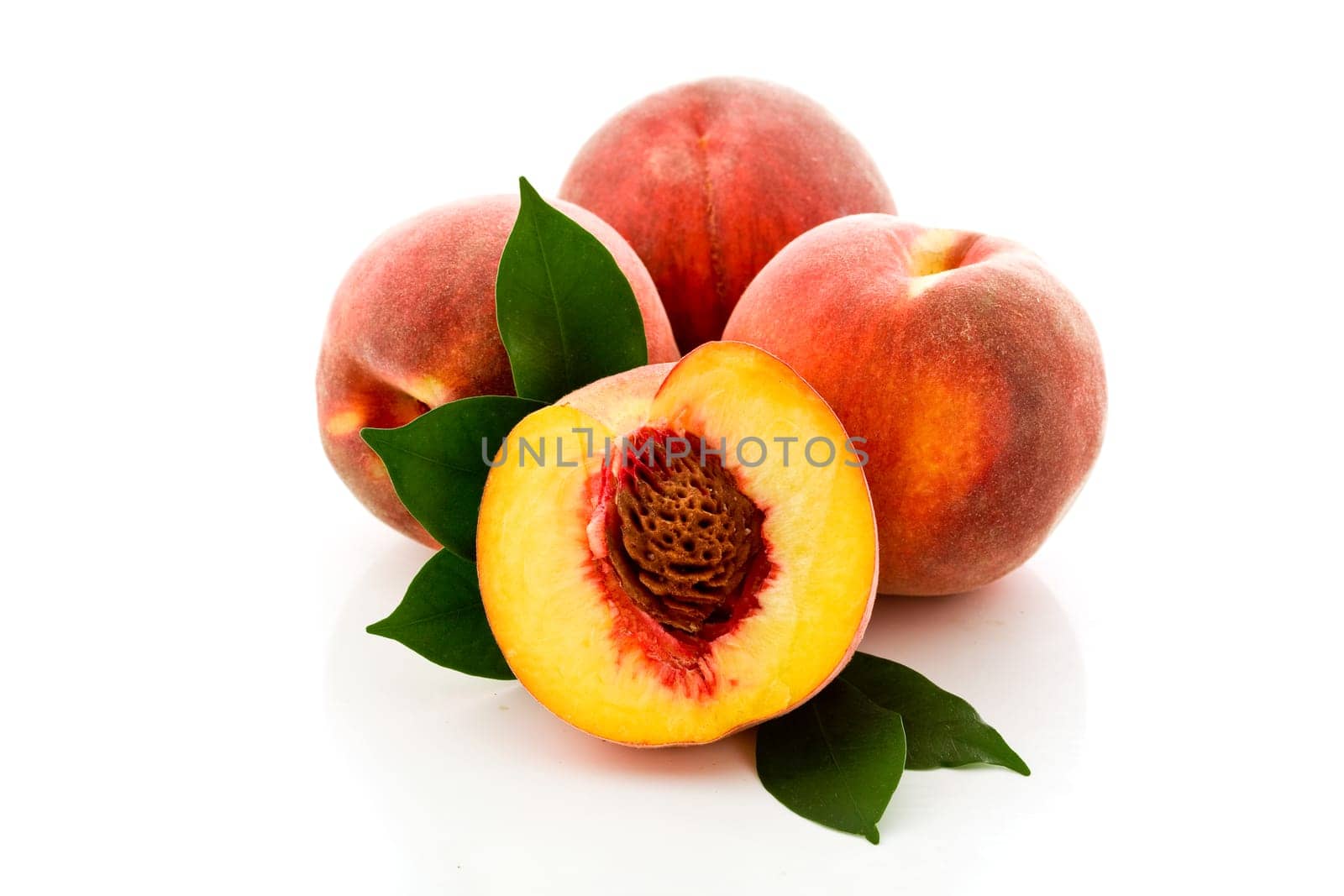 photo of delicious tasty peaches on white background with leaves