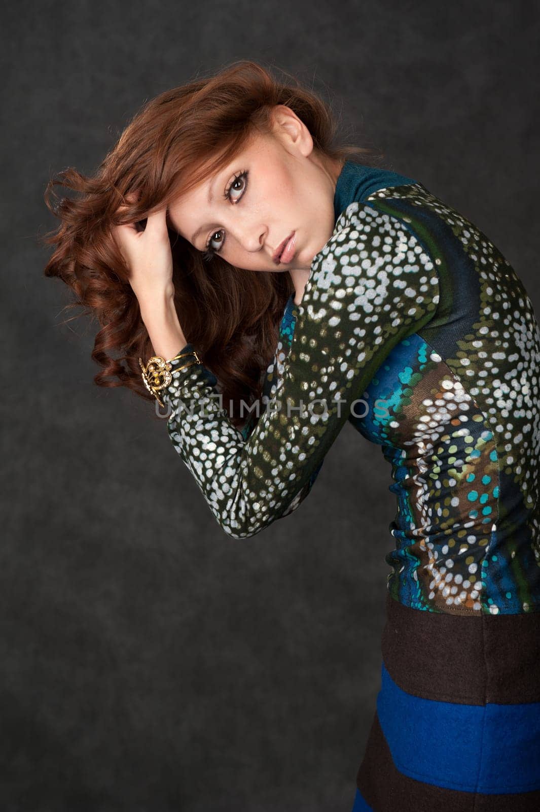 Portrait of a fashion beautiful girl with curly long hair
