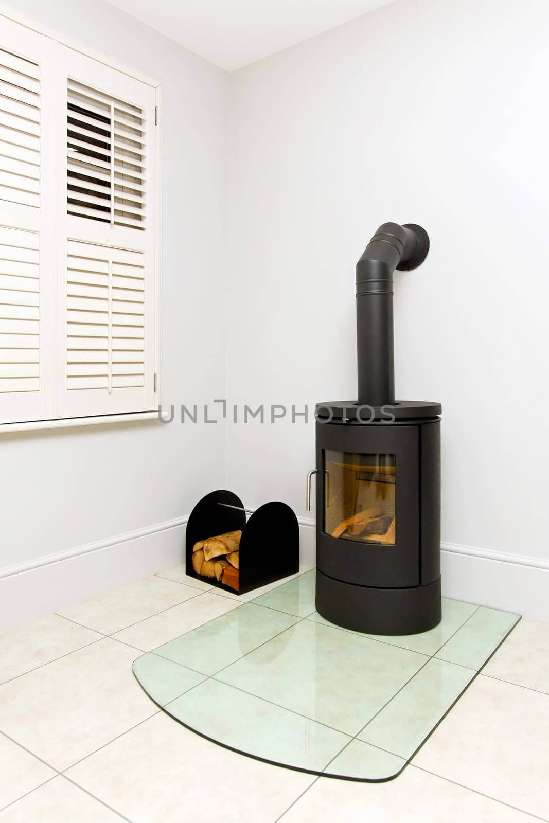 Freestanding black cast iron wood burning stove.