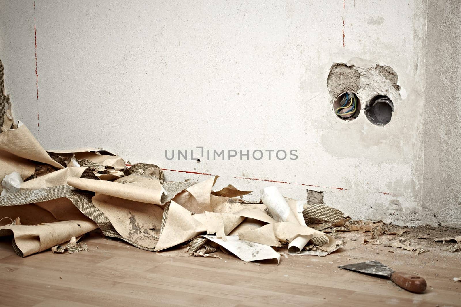 dirty room with wallpaper on the ground