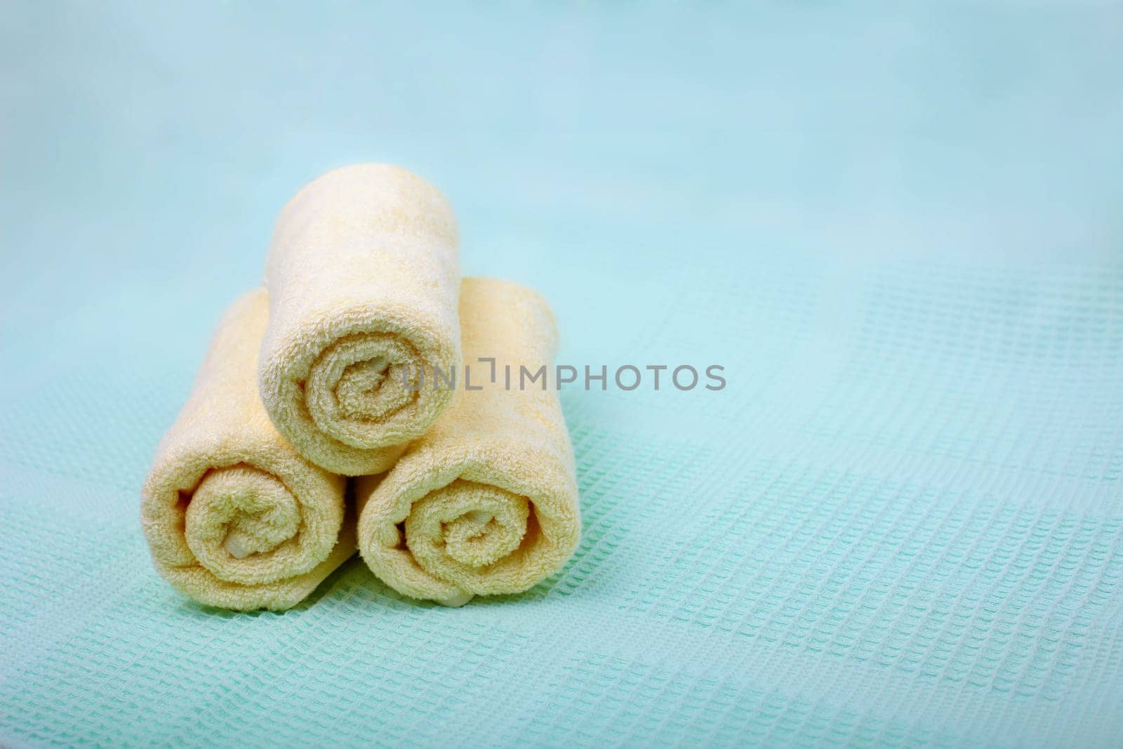 Ivory Spa towels on a blue background