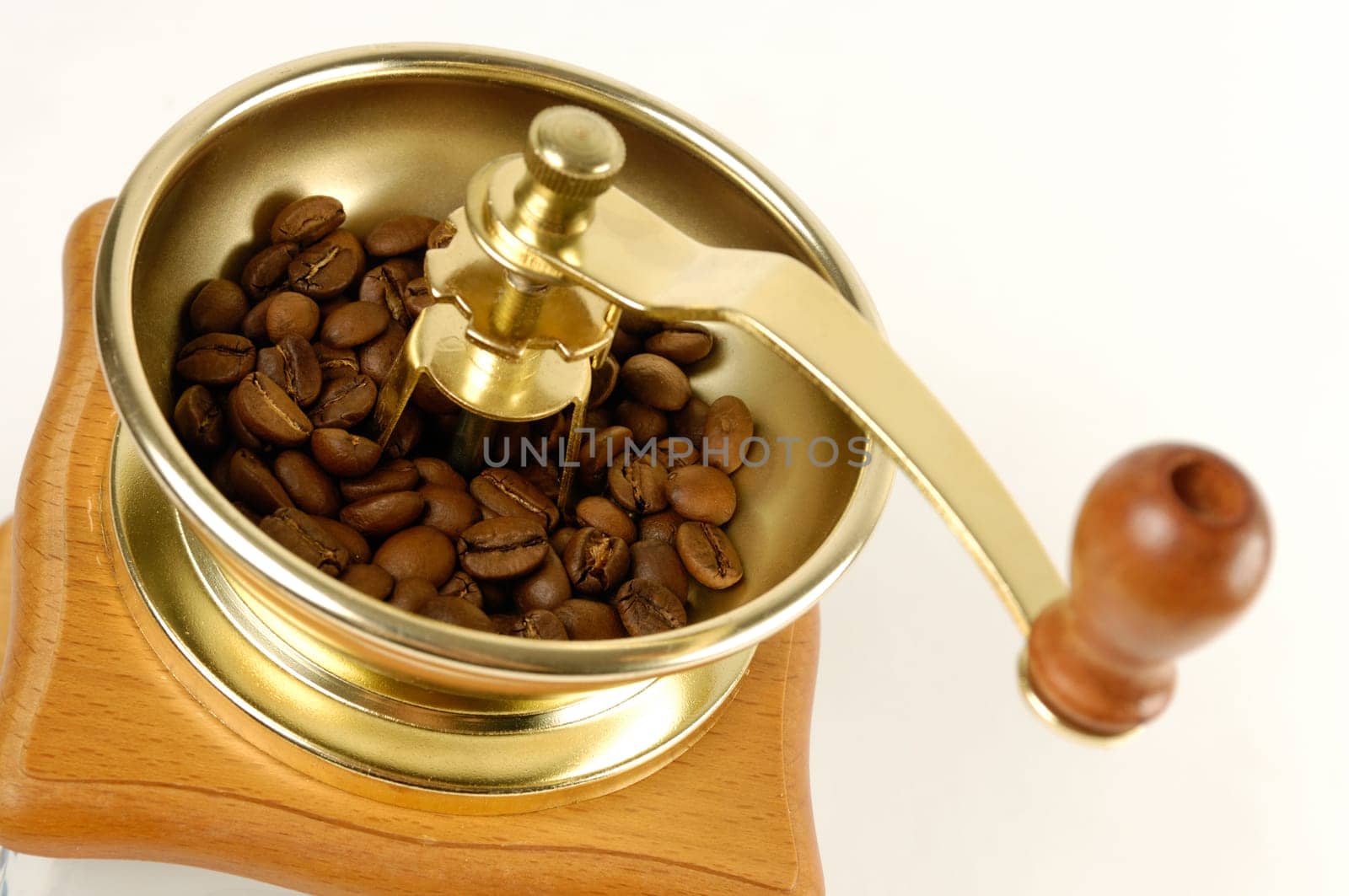 Stock photo of a Coffee grinder with coffee beans close-up Isolated over white background