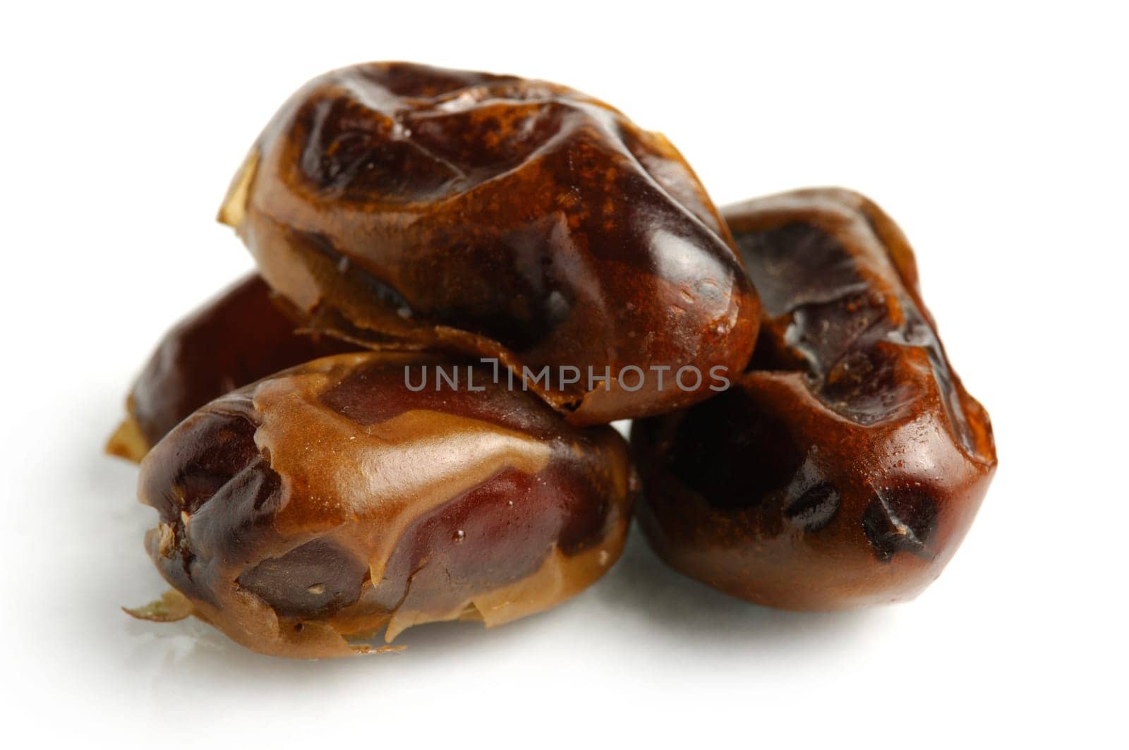 Dried Mazafati dates close-up Isolated over white background