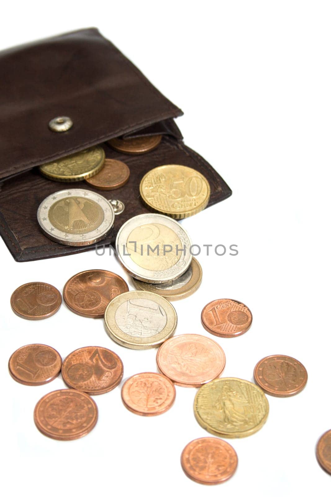 Euro coins spilling out of open leather wallet  isolated on white background.