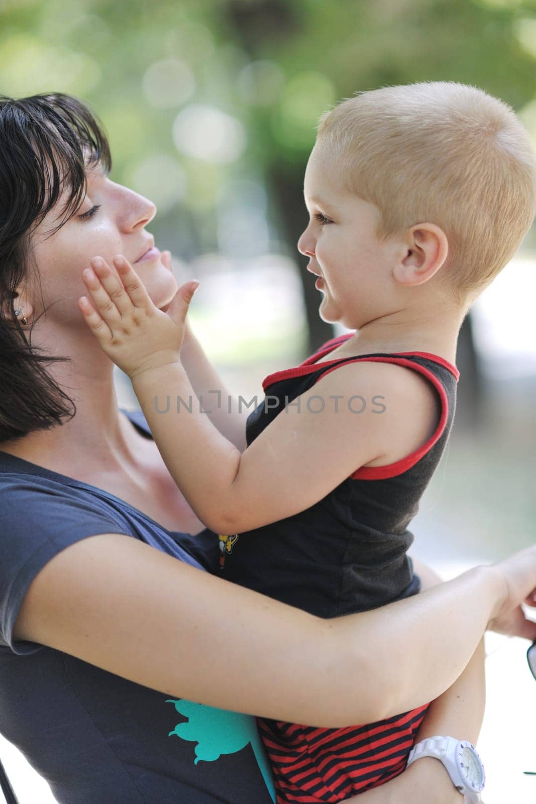 happy children and mom have fun at beautiful park on summer season
