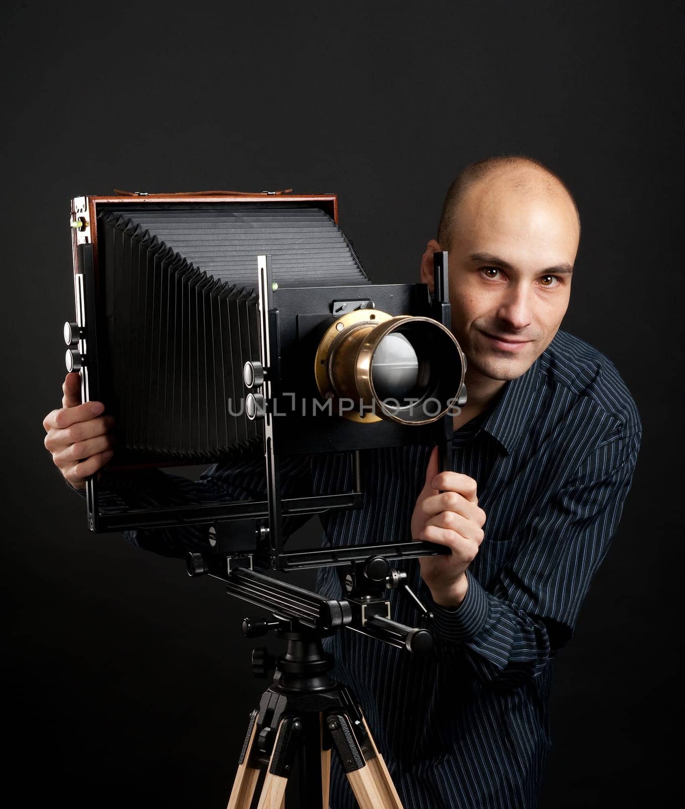 young man with retro camera in the dark