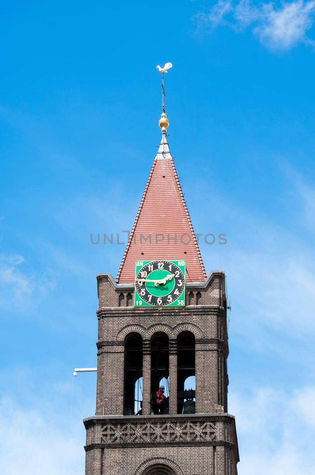 worker in clock tower of Maria-church in Enschede, netherlands