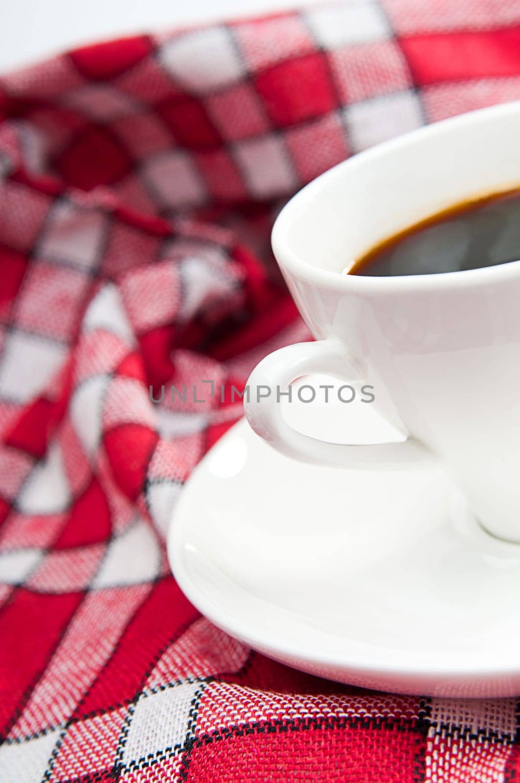 cup of coffee is on a white saucer