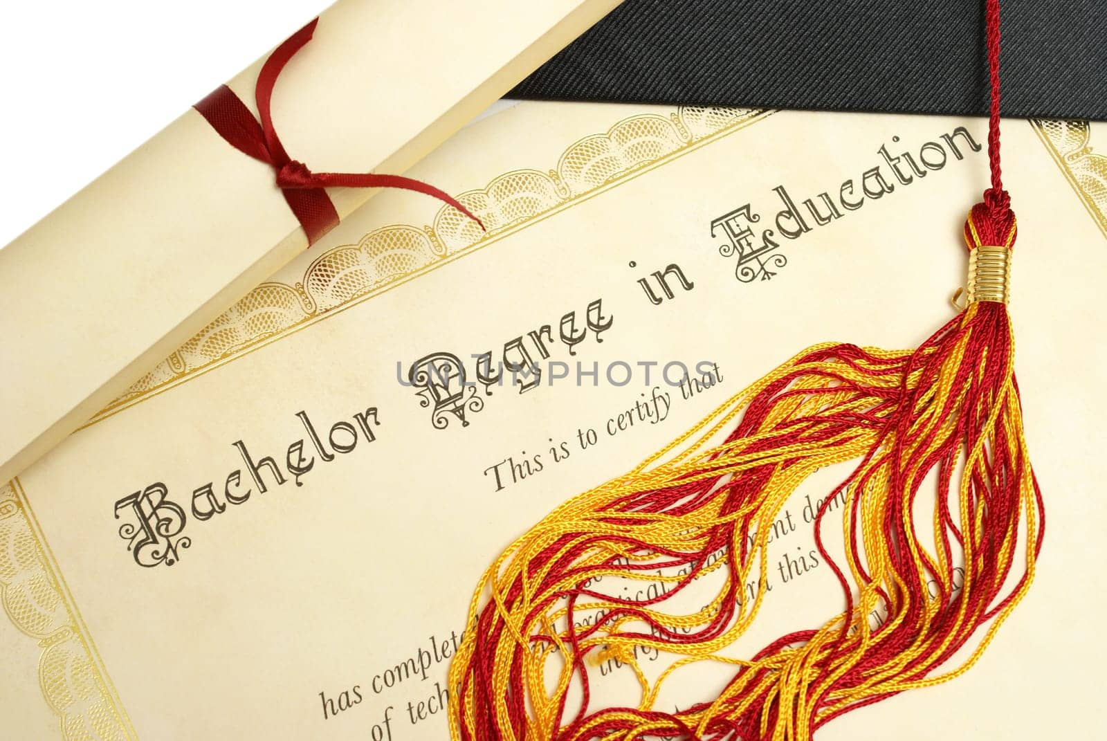 A diploma and grad hat represent a high achieving student in the field of education.
