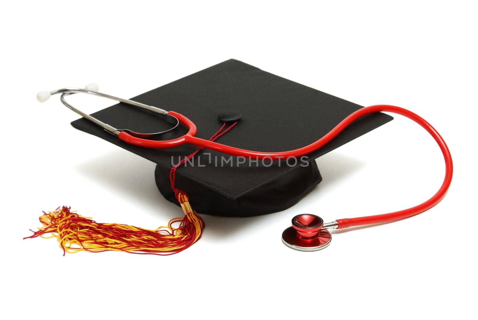An isolated mortarboard and stethoscope to conceptualize the medical graduate.