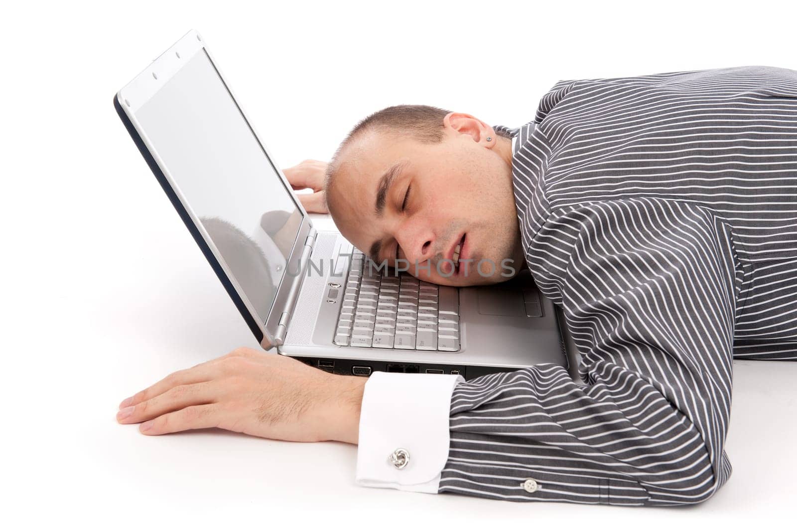 young businessman sleeping on laptop. isolated on white
