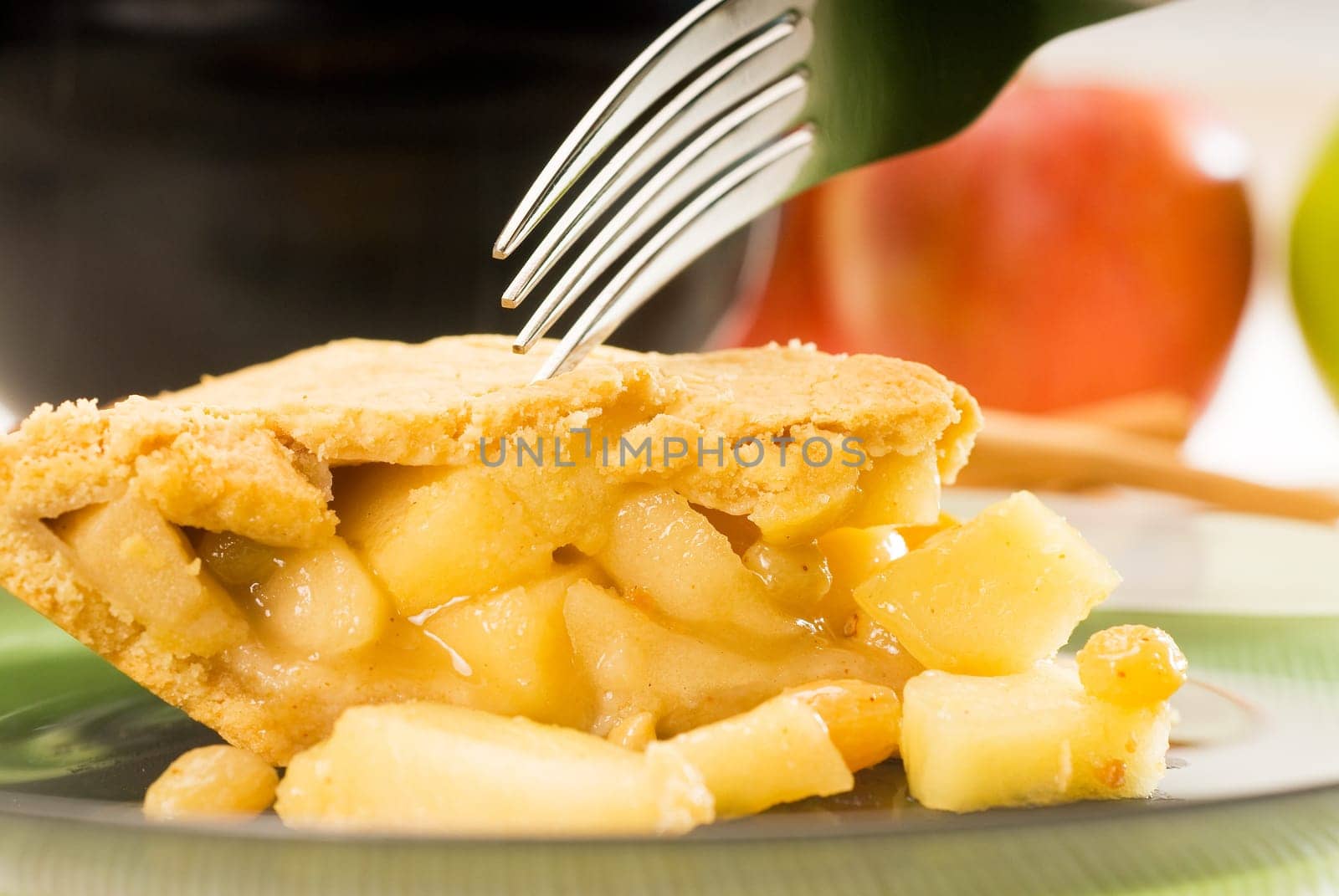 fresh homemade apple pie over green glass dish macro colseup eating  with fork