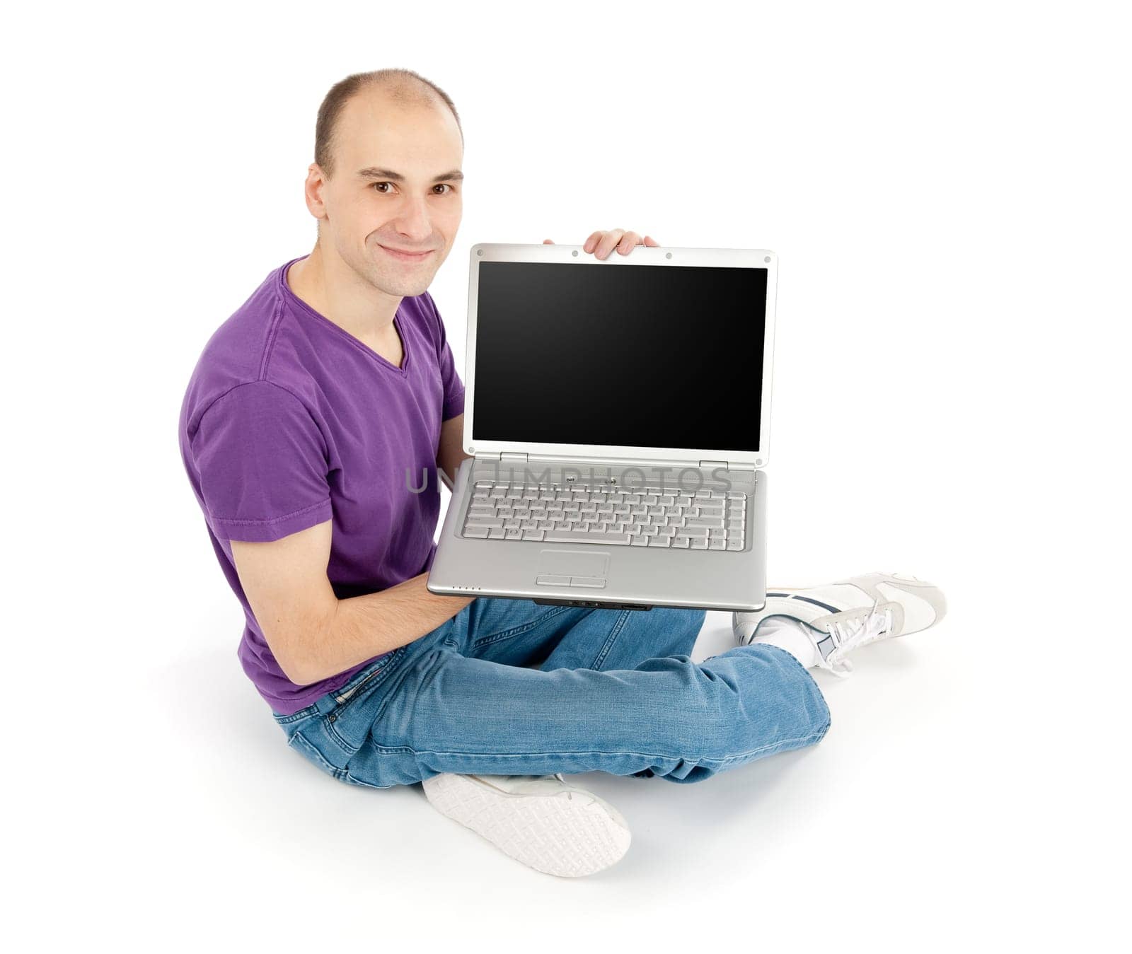 Happy young man holding laptop computer with blank screen