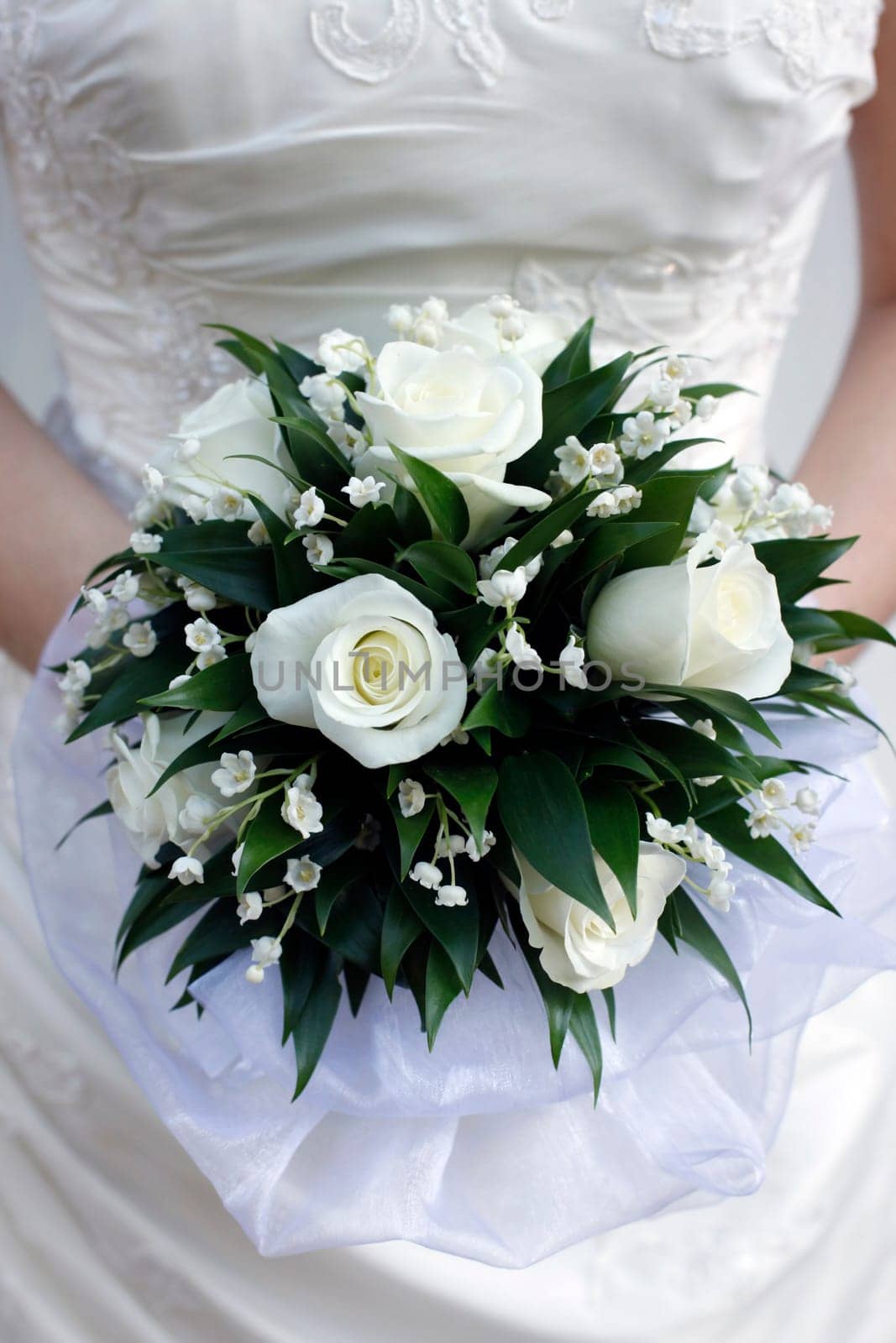 The bride holds a wedding bouquet