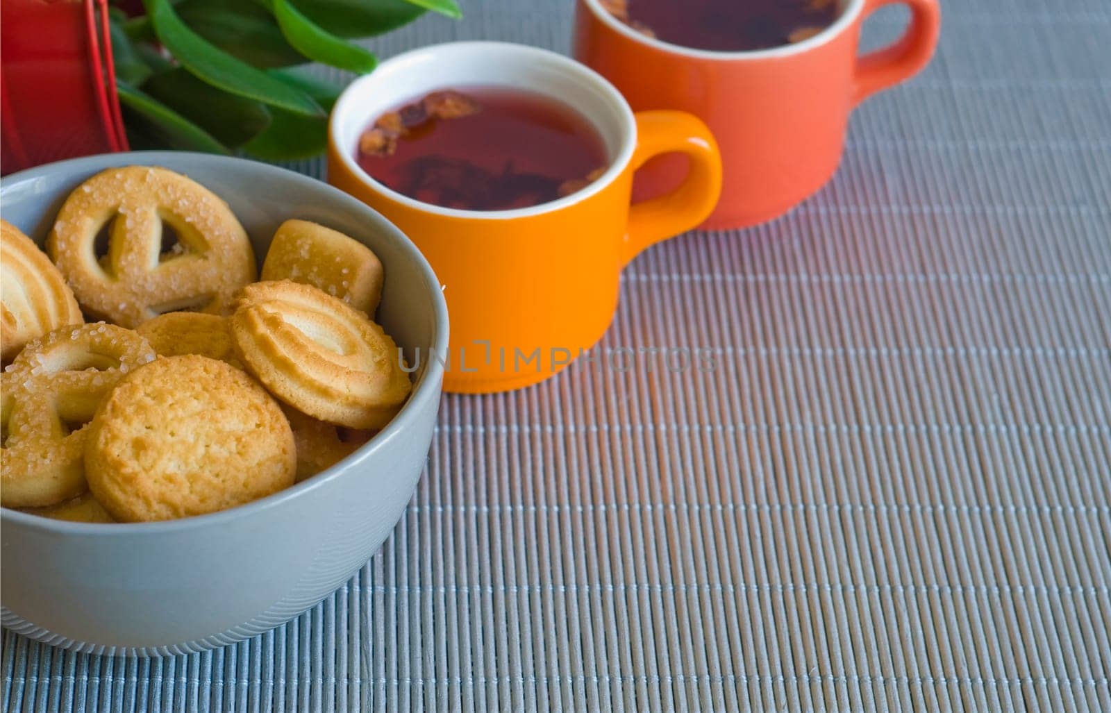 cups of fruit tea and cookies on a woven mat (shellow DOF