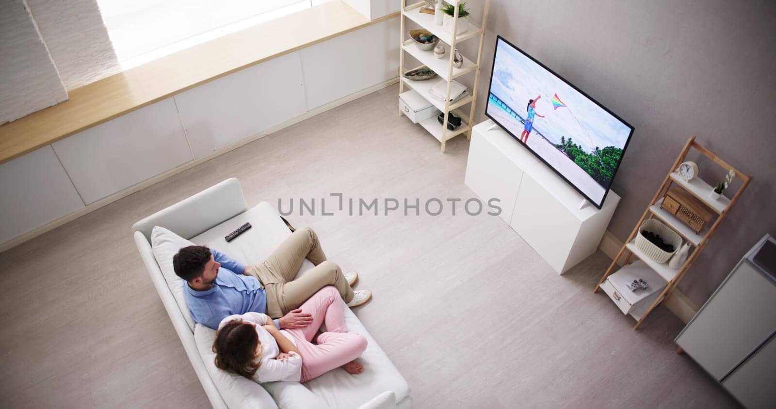 Portrait Of Young Woman Sitting On Couch Watching Movie