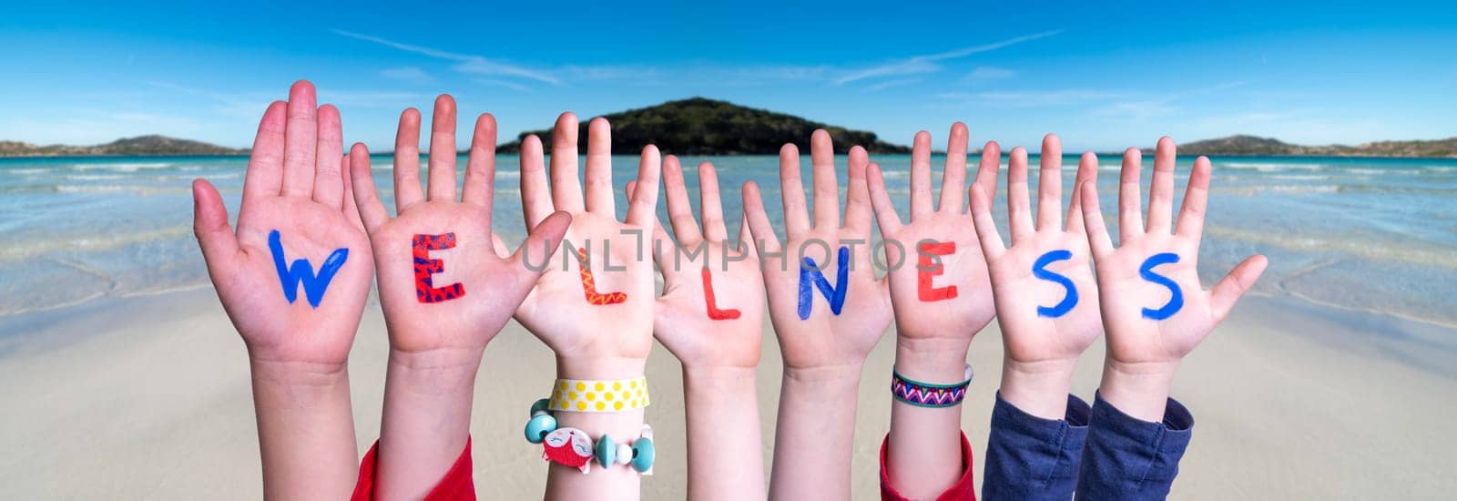 Children Hands Building Colorful English Word Wellness. Summer Sea, Ocean And Beach Background
