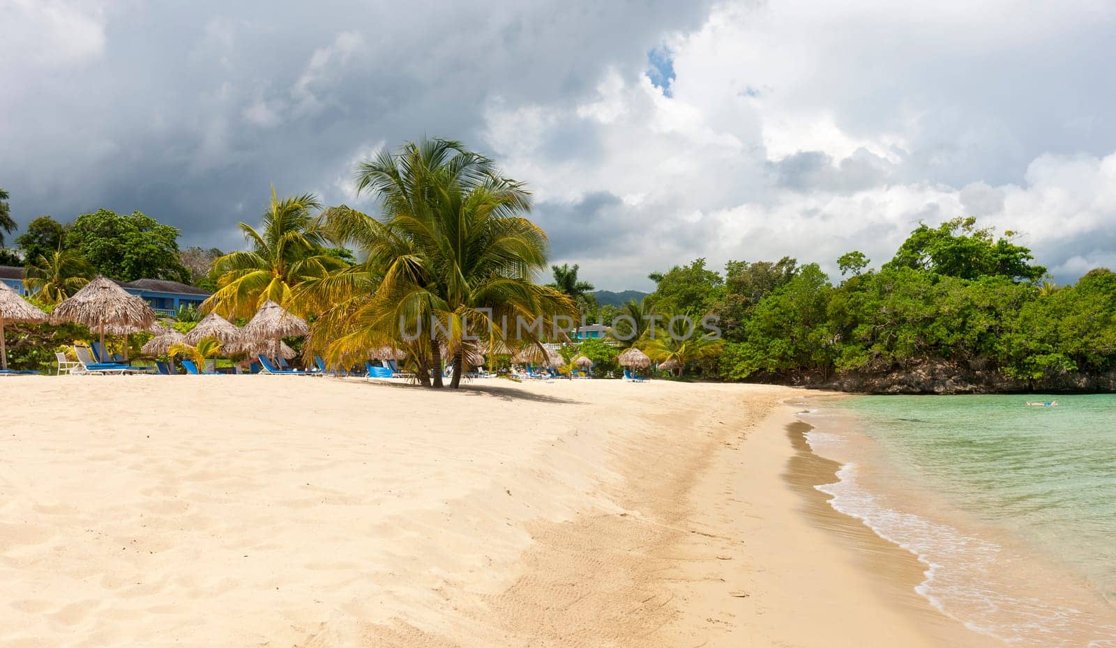 Beach on the tropical island. Clear blue water, blue sky. Beautiful vacation spot.