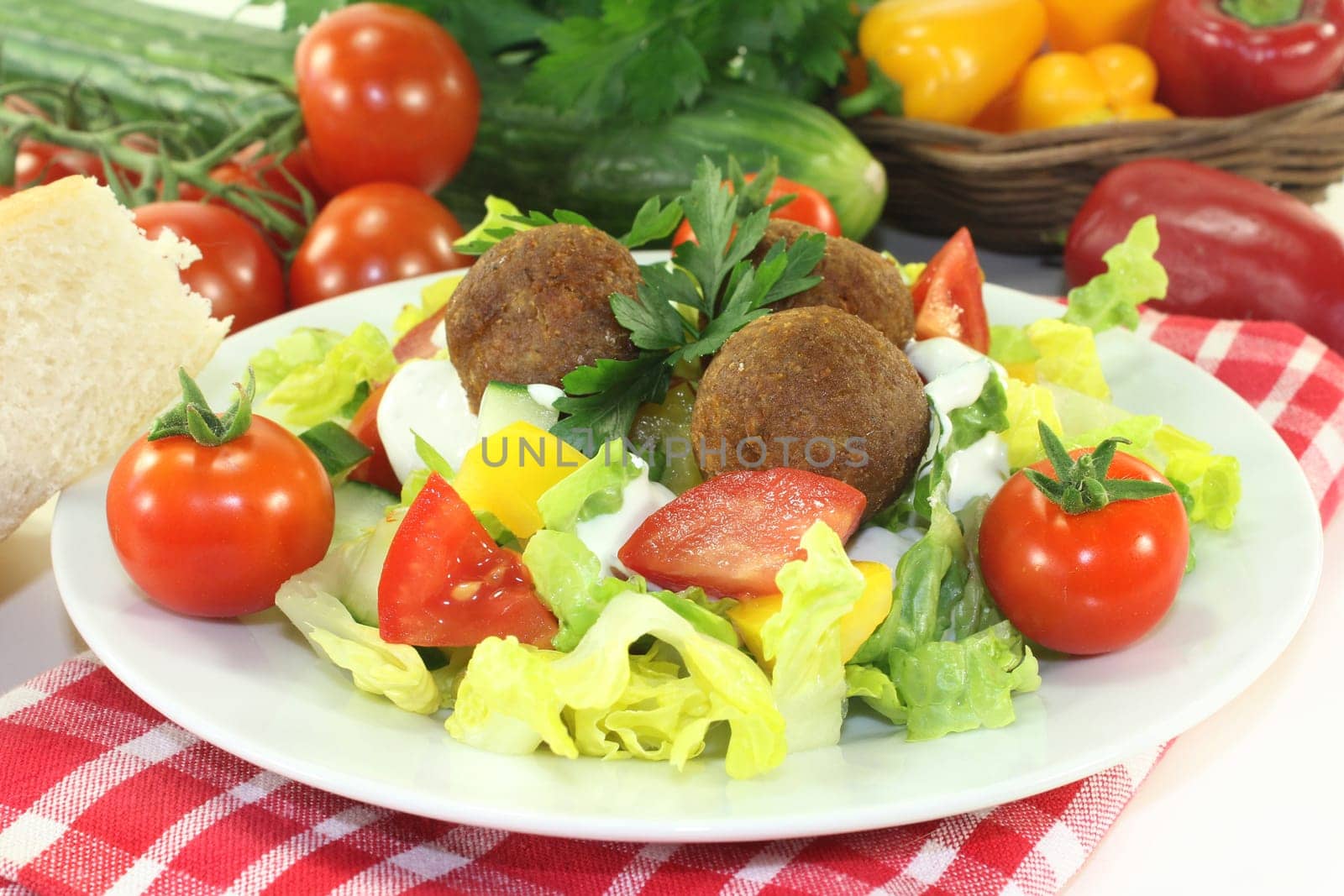 Falafel with fresh salad against a bright background