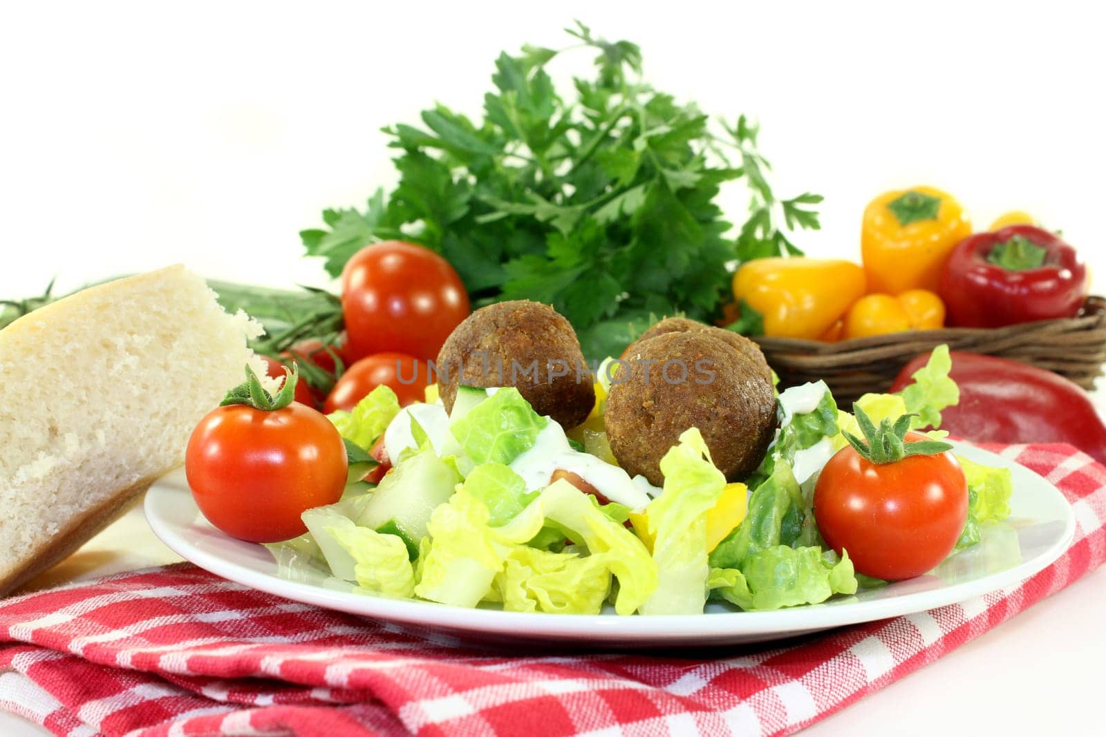 Falafel with fresh salad against a bright background..