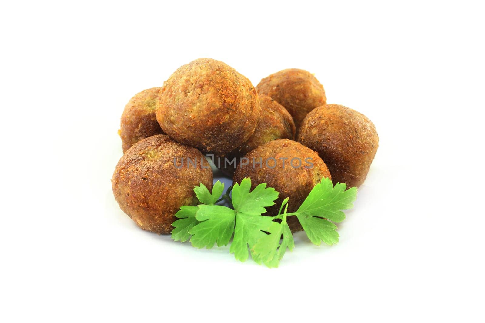 Falafel with fresh parsley against a bright background