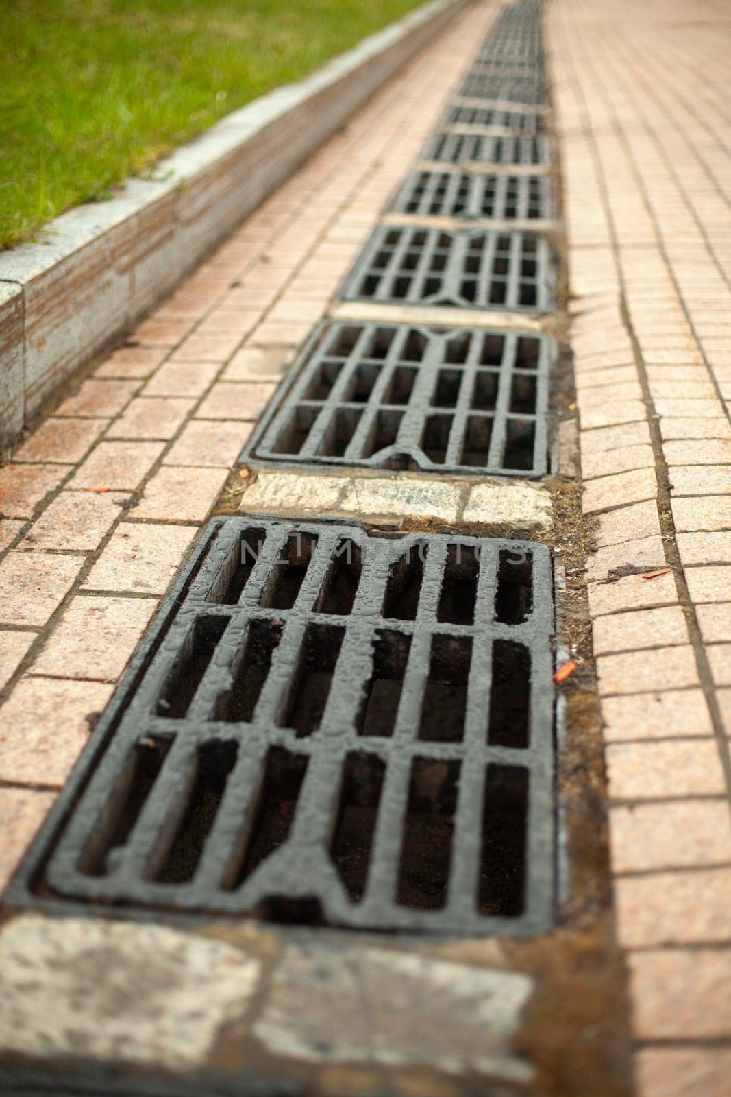 Storm drain for water drainage. Details of urban communications. Canal hatches. Grate on road. Runoff for rainwater.