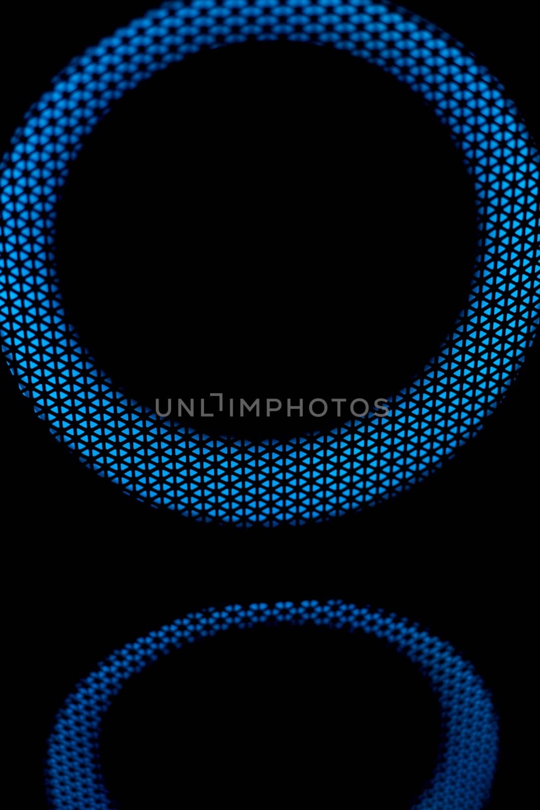 Blue circle in dark. LED glow. Abstract background on black. Mesh structure. Blue glow.