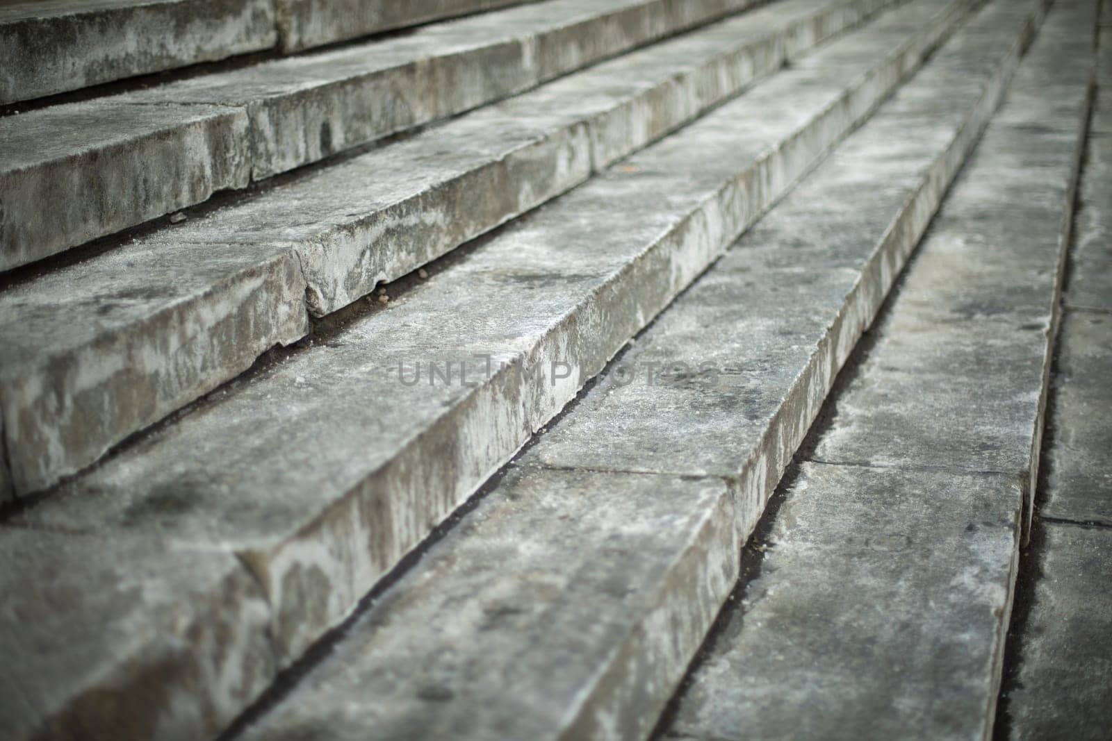 Steps on street. Architectural details. Dirty steps. Stone slabs.