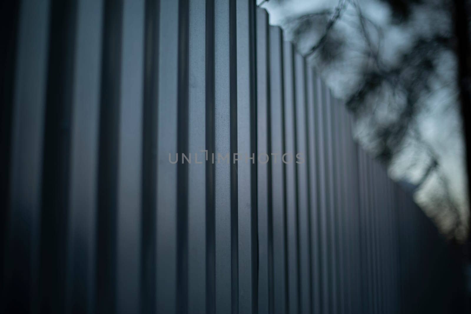 Steel fence. Fence is in detail. Metal profile sheet. Private territory.