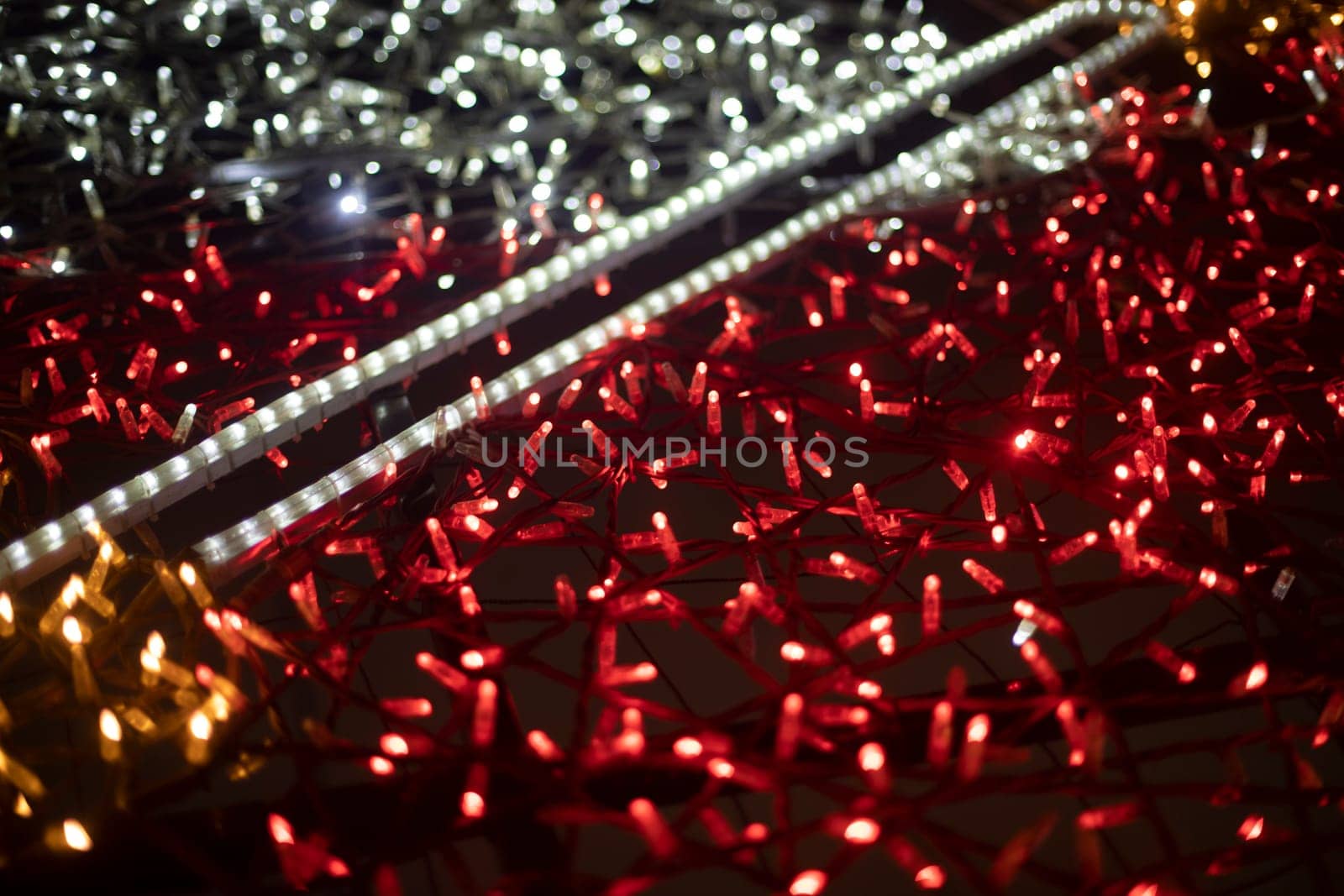 Red garlands. Texture made of LEDs. Bright lights. Decoration in city.