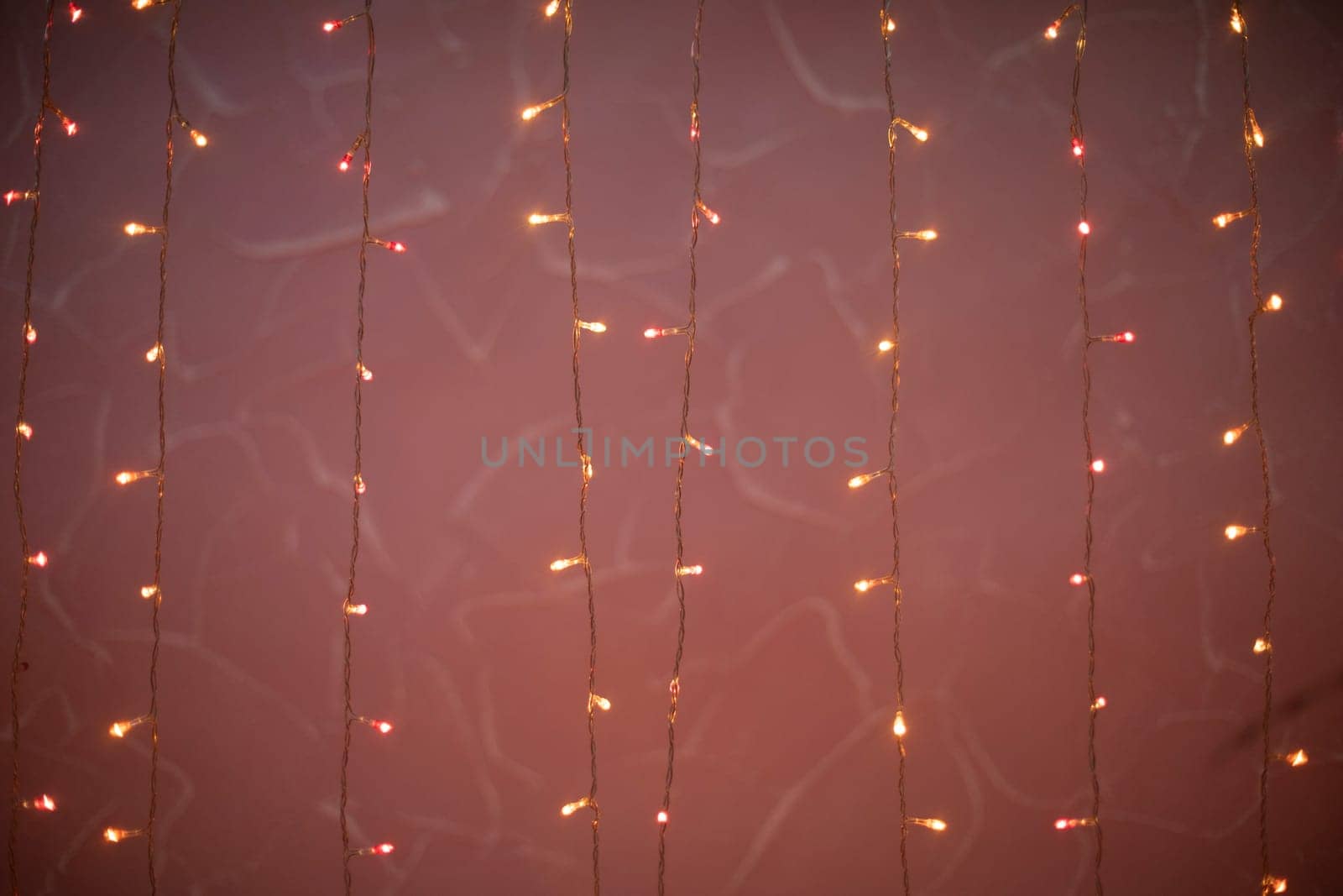Pink garlands. Light bulbs on threads. Little lights in dark. Bright decoration.