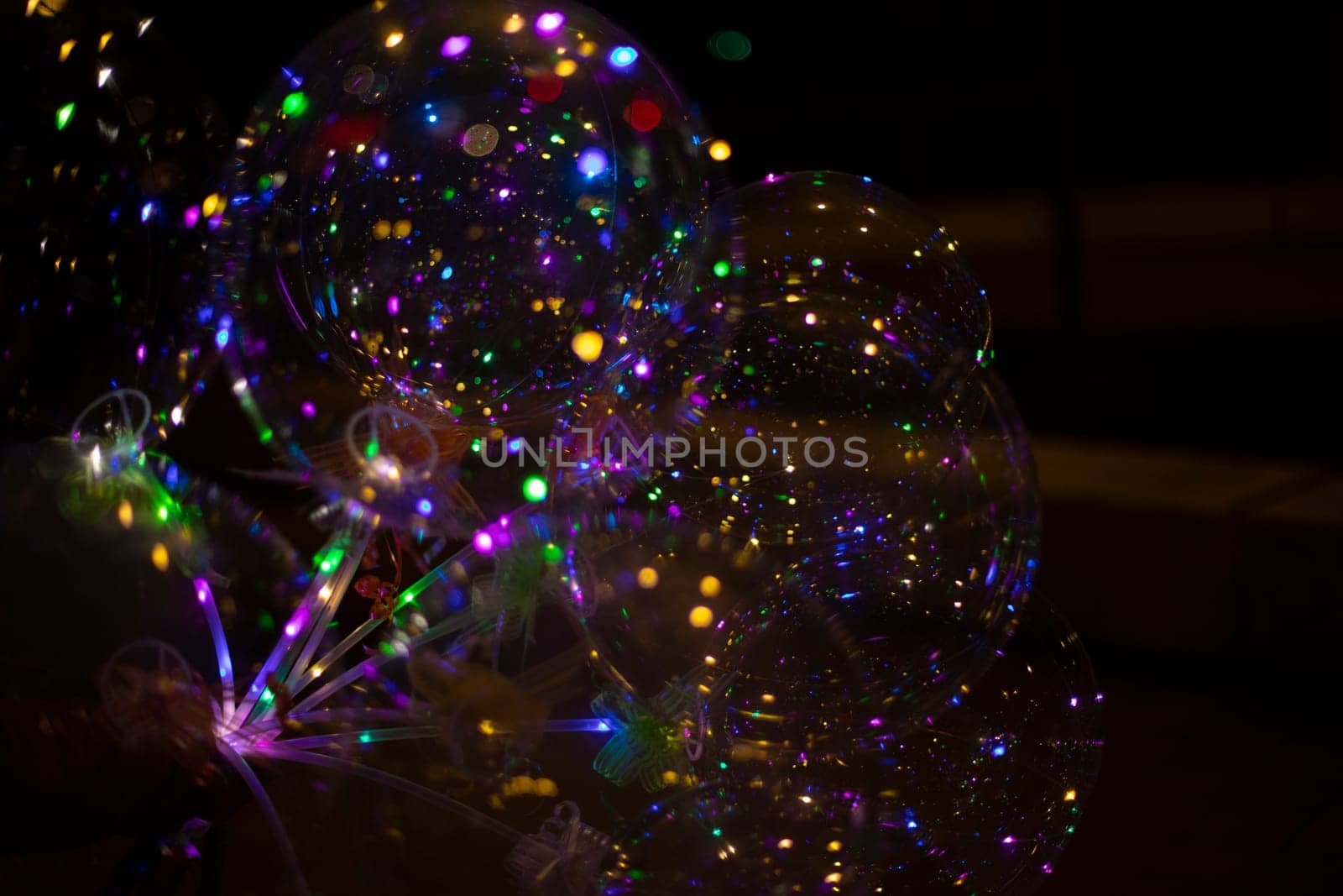 Colored balls in dark. LED Light. Transparent ball with colored lights. Beautiful glow.