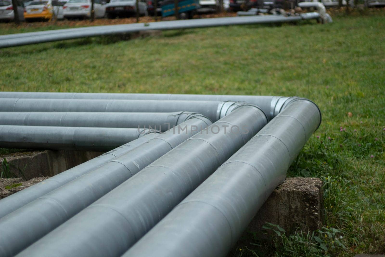 Steel pipe. Water pipeline in city. Metal profile. Urban communications.