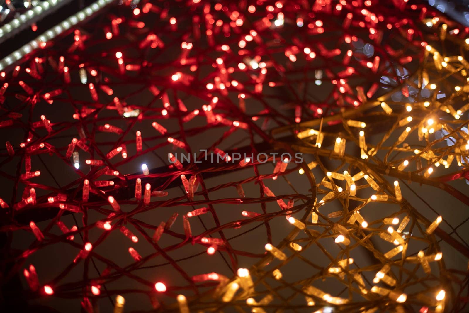 Red garlands. Texture made of LEDs. Bright lights. Decoration in city.