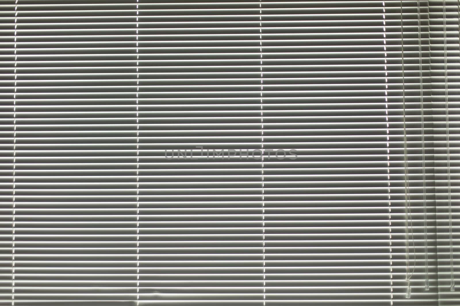 Blinds in apartment. Window is closed from light. Texture of blinds. Window opening.