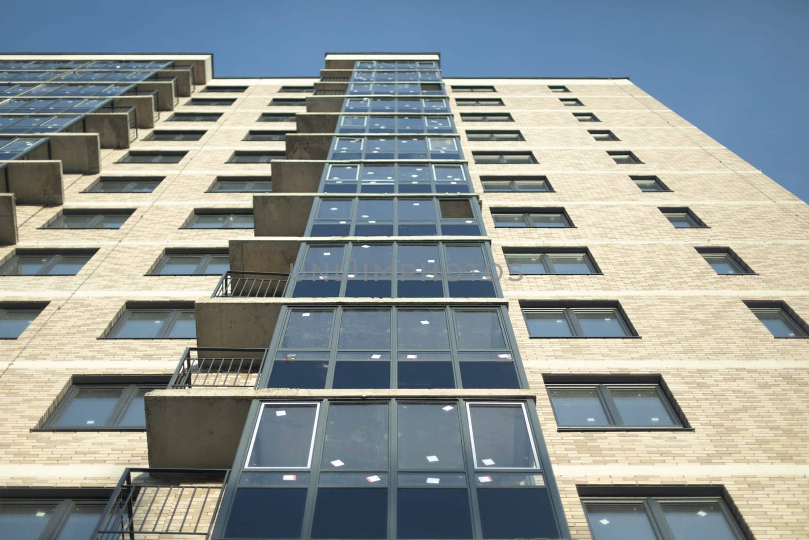 New building in city. Windows and balconies. Uninhabited house. New housing.