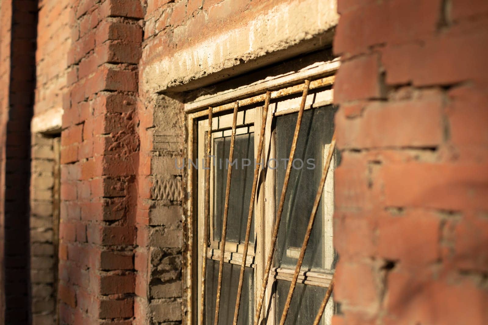 Building is made of brick. Old building. Architecture of 19th century. Window in wall.