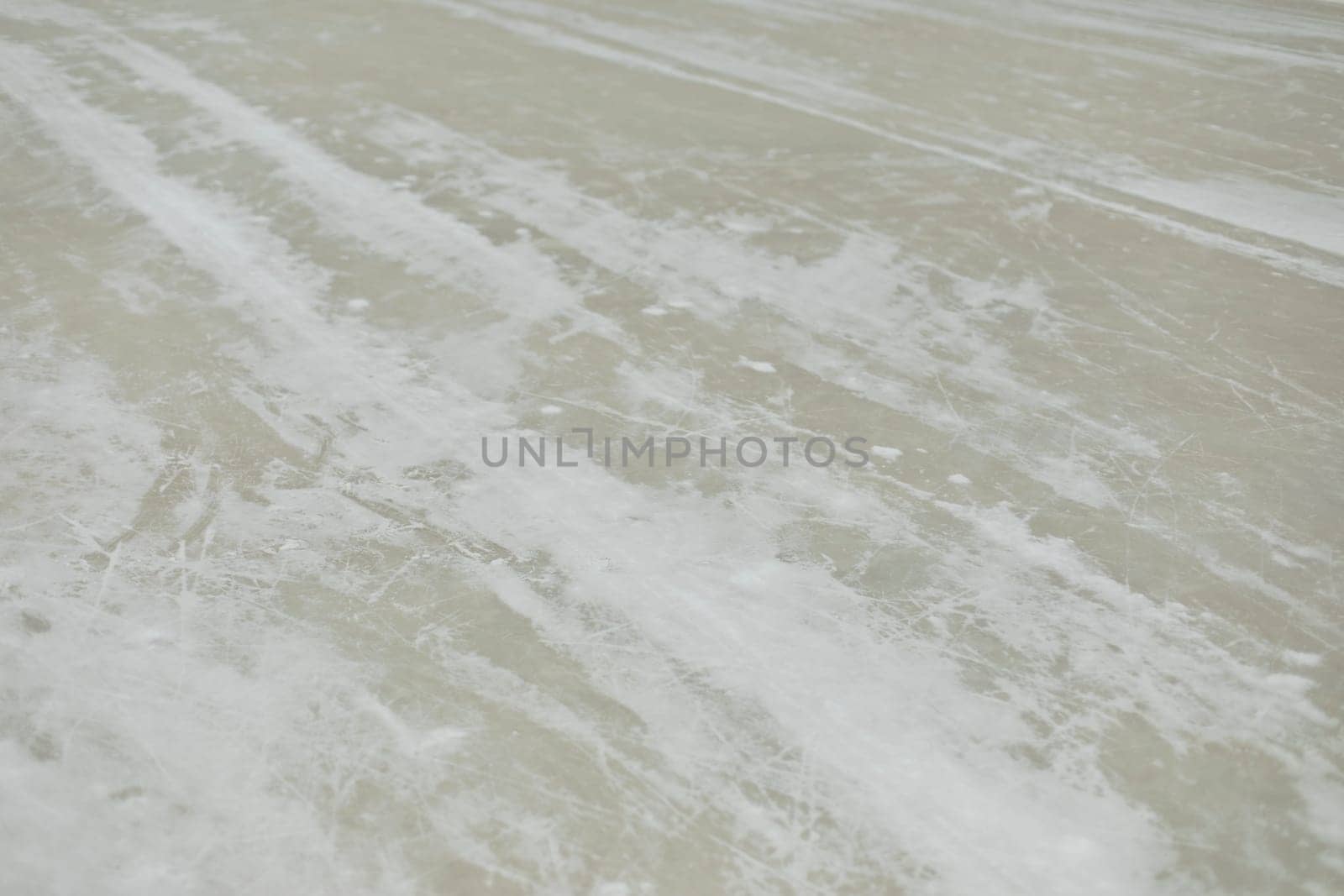Ice in snow. Ice in hockey stadium. Texture of snow. Roller parts.