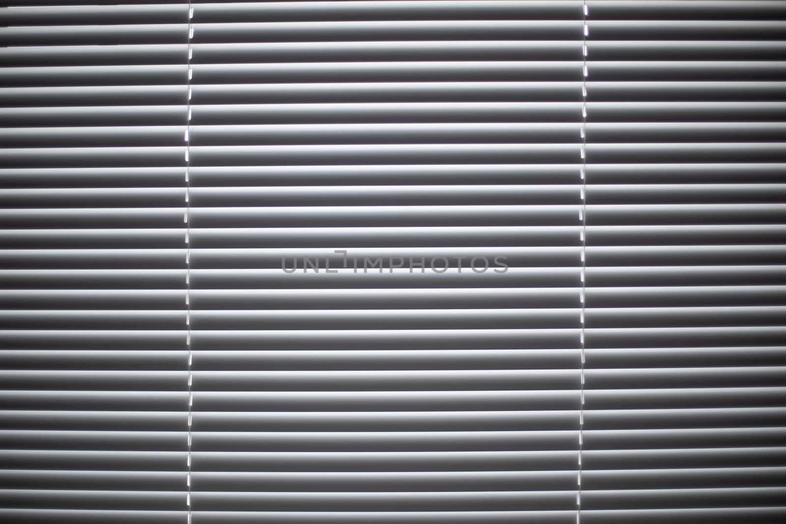Texture blinds. Window in detail. Light from window. White blinds closed.