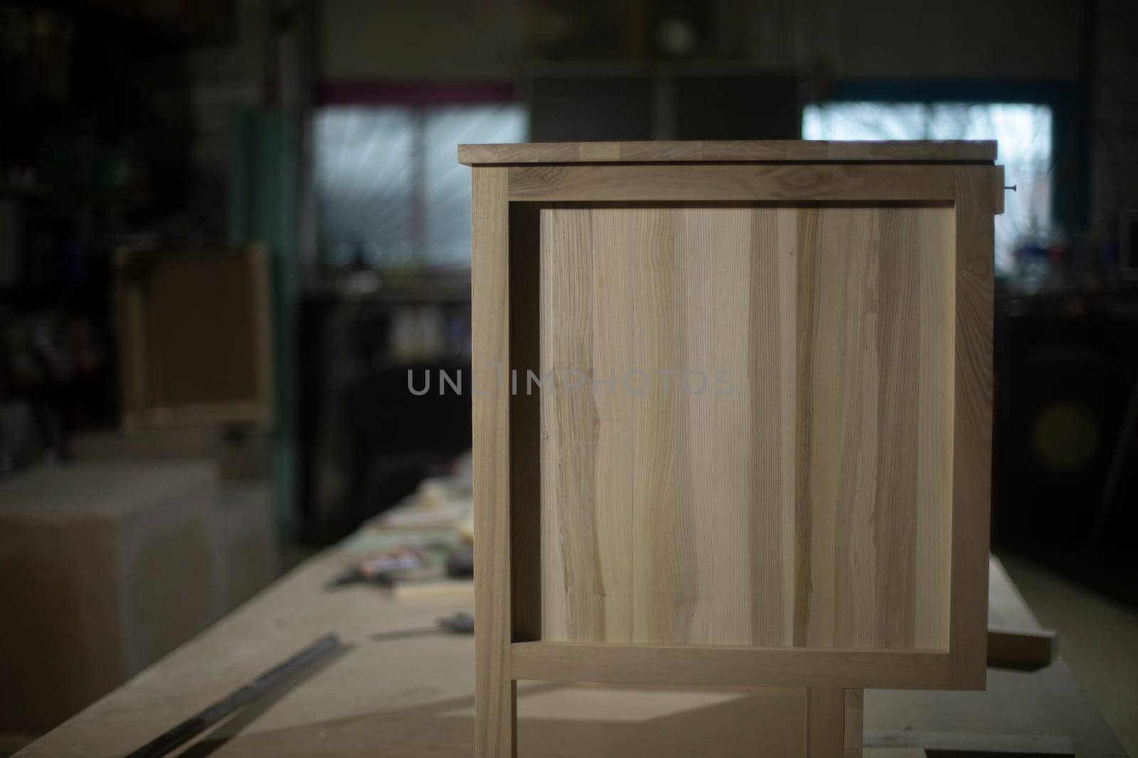 Furniture made of wood in carpentry workshop. Table of boards. Production details.