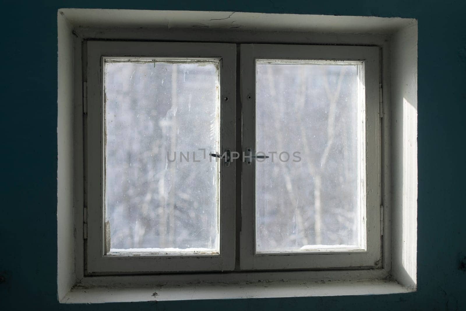Window in building. Interior of building in detail. Window frame from inside. Light through glass.
