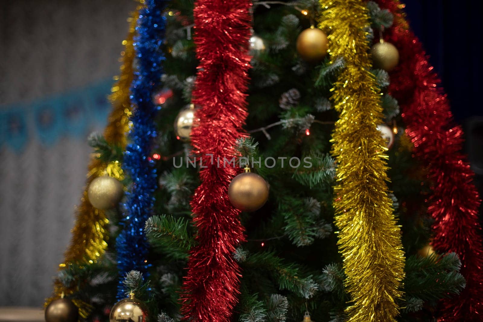 Toys and garlands for Christmas. Decorations on Christmas tree. Garlands on tree. Details of holiday.
