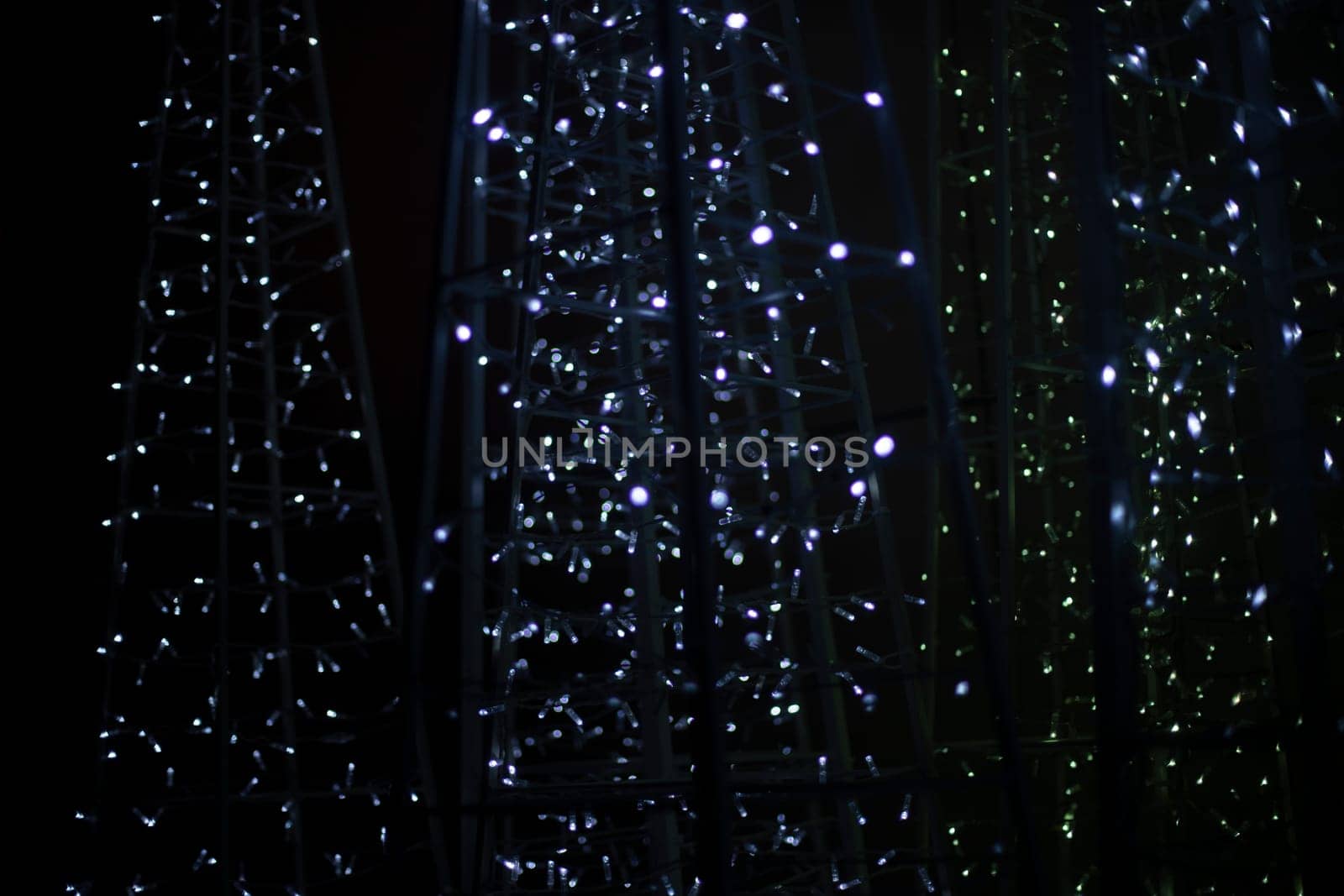 Texture from garlands. Led bulbs. White lights in dark. Glow on black background.
