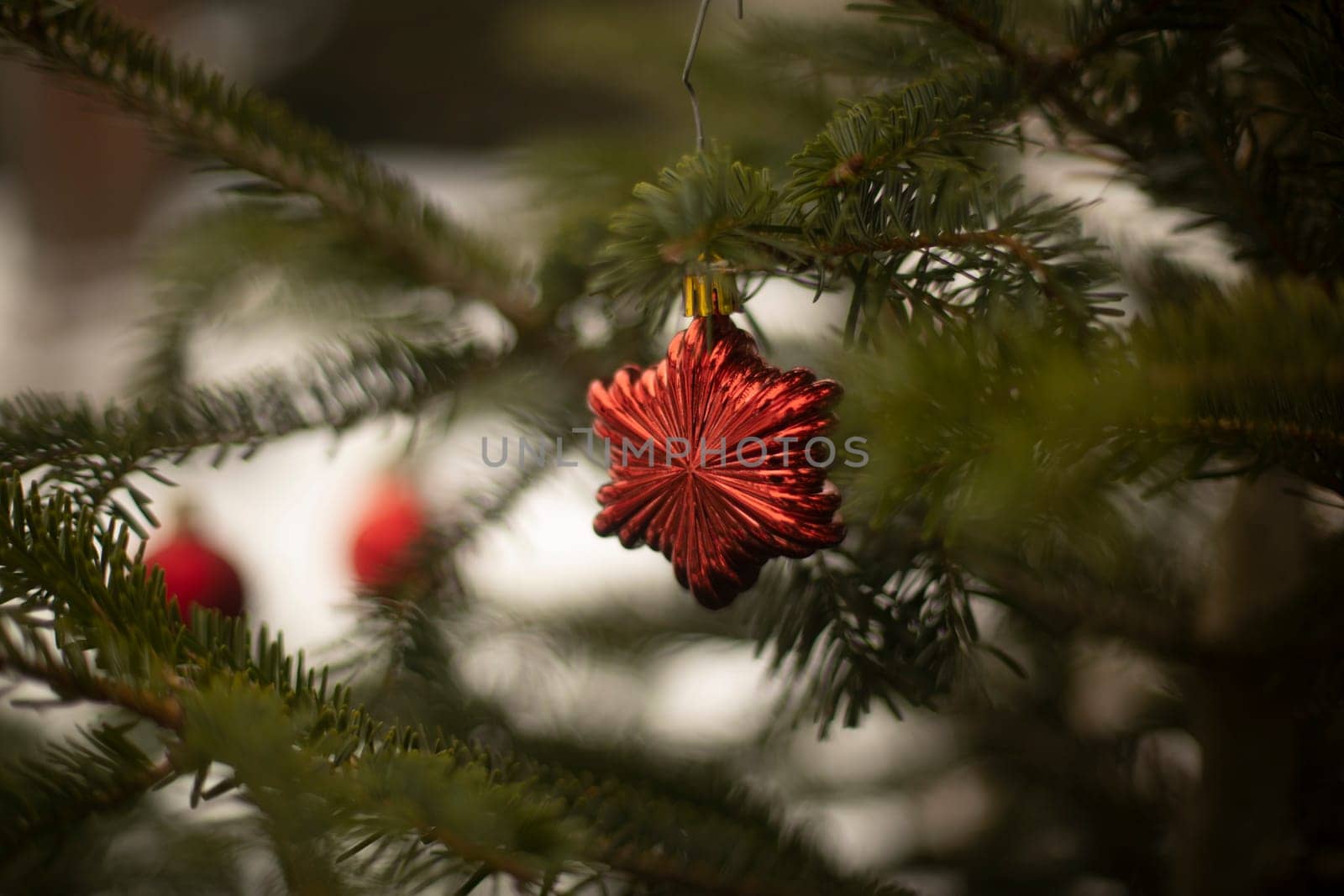 Red toys on Christmas tree. Christmas decorations. Red balls. Beautiful garlands.