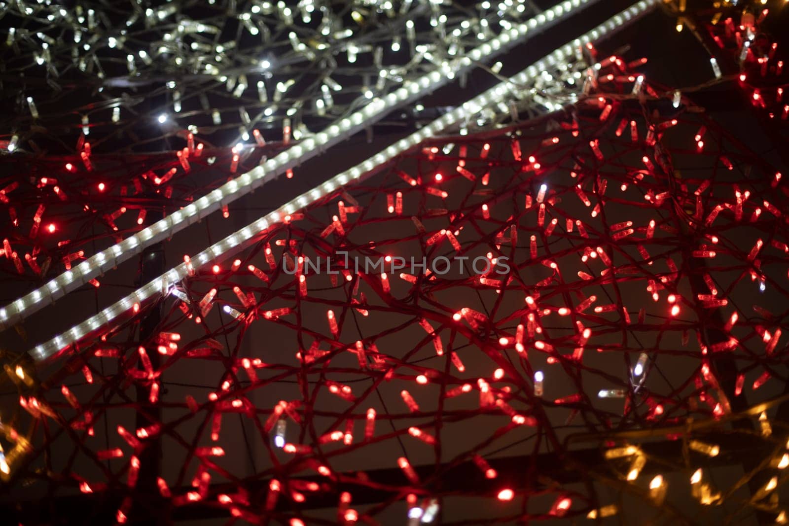 Red and yellow garlands Small bulbs. LEDs in dark. Decoration in details.