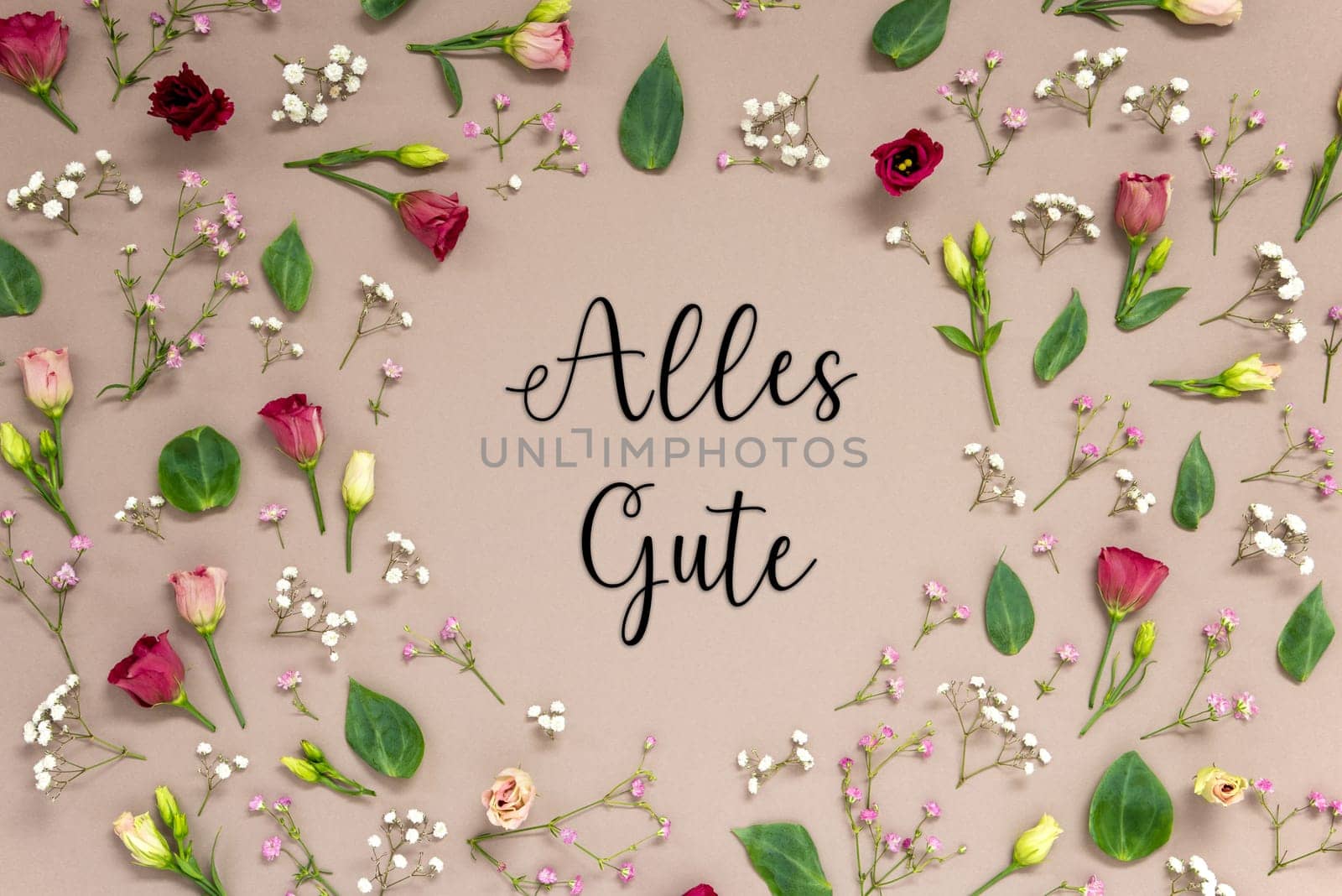 Flower Arrangement With German Text Alles Gute Means Best Wishes. Colorful Spring Blossoms And Flowers Like Roses Building A Frame. Flat Lay With Brown Paper Background