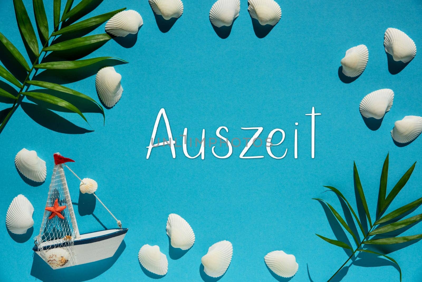 Flat Lay With German Text Auszeit Means Downtime. Turquoise Or Blue Background With Maritime Decoration Like Boat, Shells And Palm Leaf.