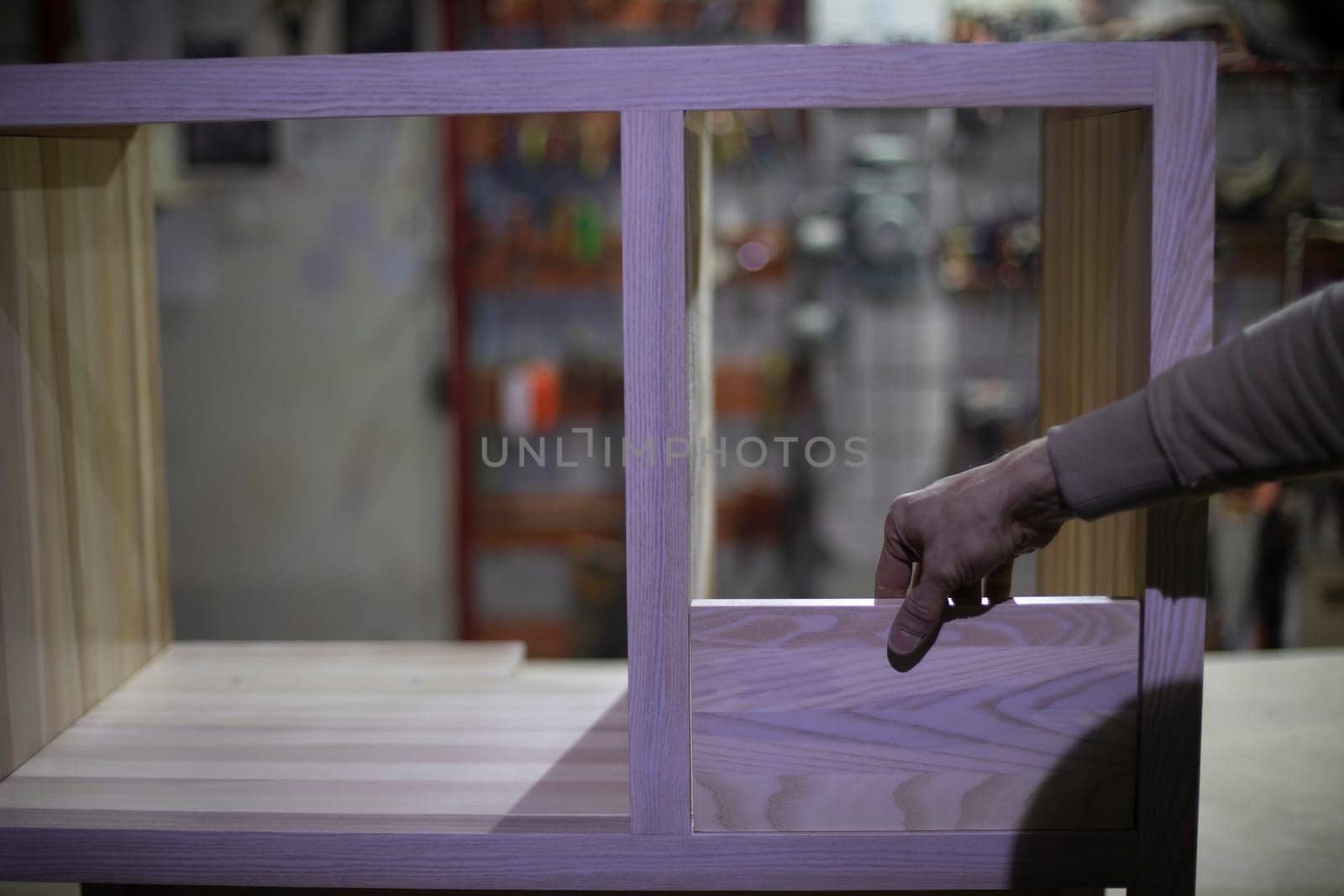 Manufacture of furniture. Guy holds board. Joinery. Work with wood.