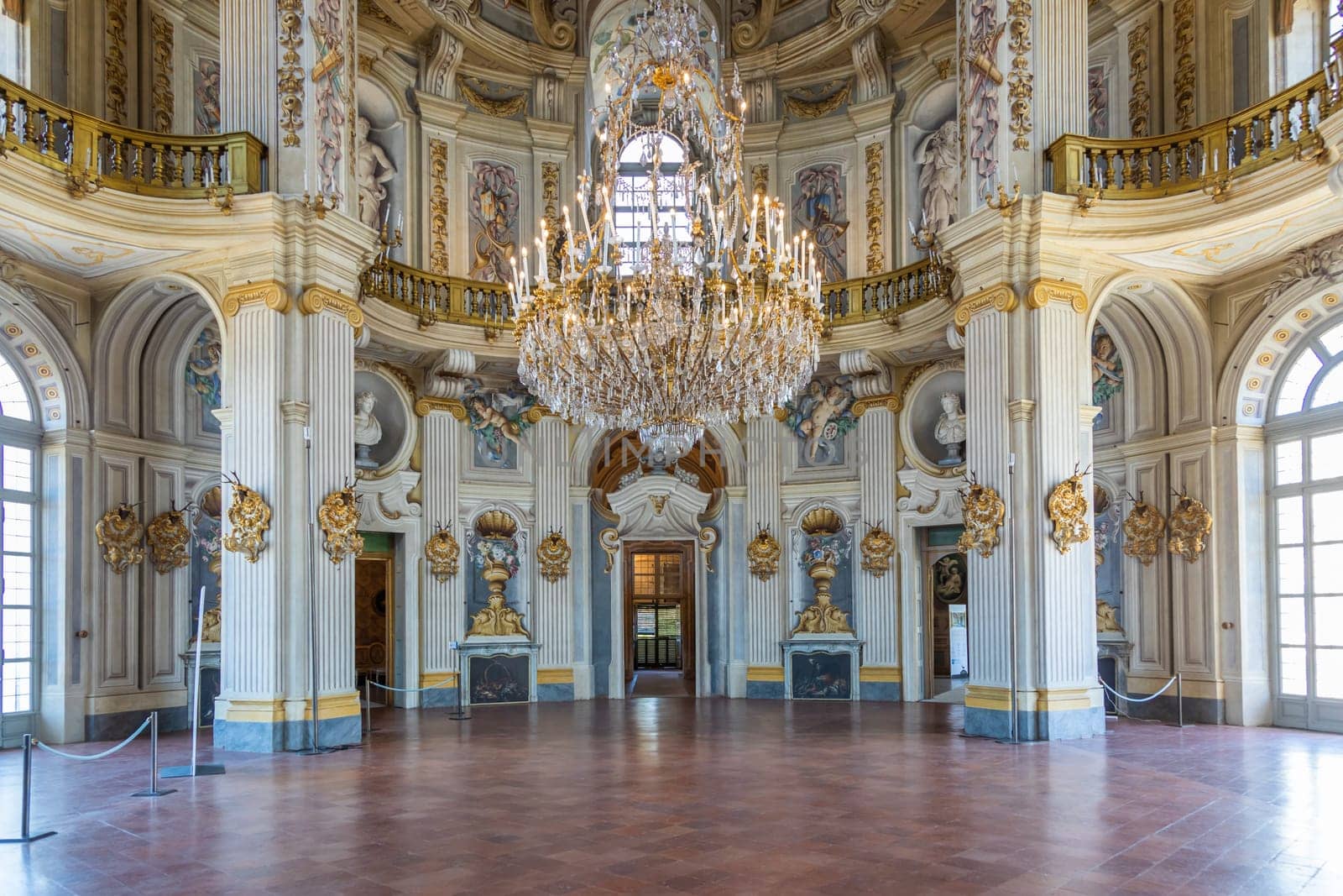 Italy, Stupinigi - January 2023: luxury interior of Royal Palace with baroque marbles and windows